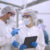 Product researcher or quality control engineer or production line worker in white sterile uniforms prevent contamination of food and drink product industry or cosmetic manufacturing plants or processed food or canned food, discuss about product at factory
