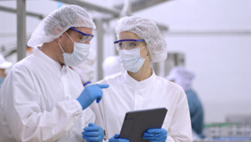 Product researcher or quality control engineer or production line worker in white sterile uniforms prevent contamination of food and drink product industry or cosmetic manufacturing plants or processed food or canned food, discuss about product at factory